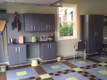 Garage storage cabinets and garage flooring create a hard-working and beautiful space.