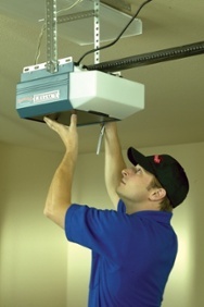 A Man Installing a Garage Door Opener | Garage Door Reversing